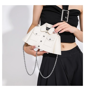 Detailed view of creative cream shirt-shaped shoulder bag with silver metal chain
