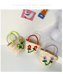 Close-up of handmade straw baskets featuring 3D crochet flowers and vibrant colorful handles