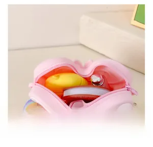 Macro detail of pink silicone butterfly bag showing internal storage for small items
