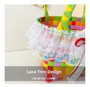 Close-up of colorful woven texture featuring delicate white lace trim and red ribbon bow