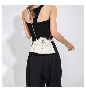 Detail of creative cream jacket shaped crossbody bag with metallic buttons and chain strap