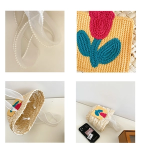 Detail of woven straw bag with crochet flower, pearl handle, and ribbon strap