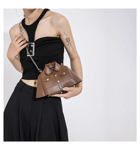 Detailed close-up of brown jacket-shaped creative crossbody bag with lapels and chain