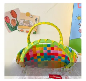Detail of colorful woven basket with lace trim, red silk bow, and comfortable handle
