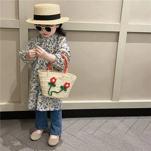Kids hand-woven straw basket bag and matching hat with floral accents for summer beach