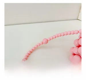 Dettaglio delle perle rosa di una mini borsa a tracolla intrecciata a mano per bambine