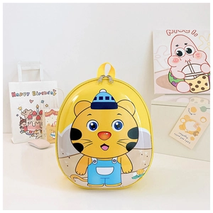 Close-up of yellow eggshell backpack with cartoon tiger design for toddlers