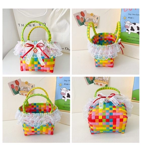 Close-up of rainbow woven basket with white lace trim, red ribbon, and strawberry charm
