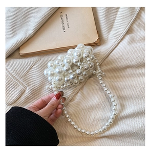 Detail view of mini woven pearl handbag with beaded shoulder strap for girls