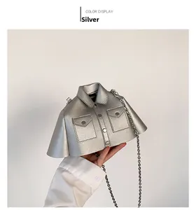 Detailed view of silver jacket-shaped crossbody bag with metallic texture and chain