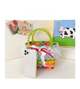 Detailed size comparison of a colorful woven girls' beach bag with lace and strawberry charm