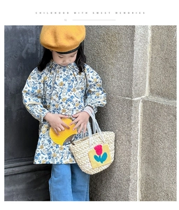 Detail of a woven straw handbag with tulip applique for children outdoor beach outfit