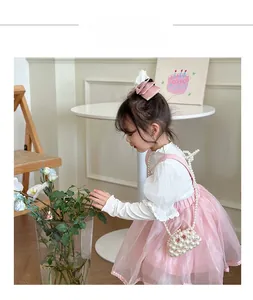 Girl's pink tulle princess dress paired with elegant white pearl beaded handbag