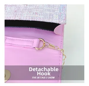 Detail of pink floral handbag showing detachable golden hook and magnetic snap closure
