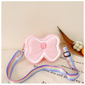 Detail of pink silicone butterfly bag for kids with rainbow strap and white trim
