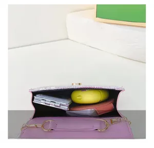 Detail showing the internal storage capacity of the pink sequin mini crossbody bag with chain