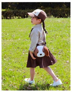 Toddler crossbody bag with cute 3D plush puppy ears and adjustable strap on a sunny field
