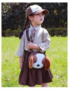 Close-up of a cute cartoon dog egg-shell crossbody bag on a girl in an outdoor setting