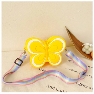Detail of yellow butterfly silicone bag with adjustable colorful striped fabric strap