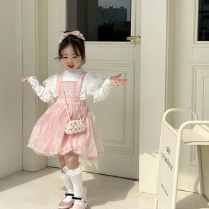 Pink girl's tiered tulle dress outfit with white puffy sleeves and pearl handbag