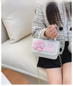 Detail of tweed girls crossbody bag with pearl handle, pink flowers and chain strap