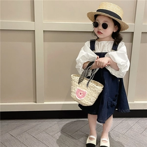 Girl summer straw handbag with flowers paired with white puff top and denim overall dress