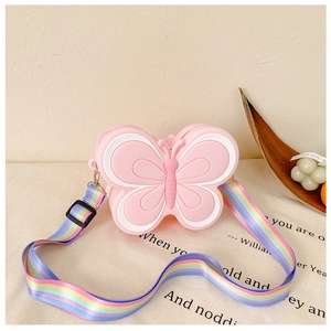 Detail of pink silicone butterfly bag for girls featuring a rainbow striped shoulder strap