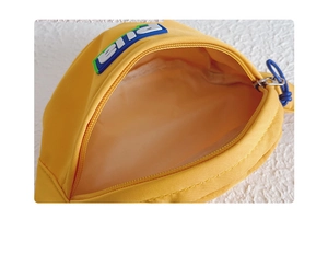 Vue détaillée du sac de poitrine en toile jaune avec fermeture éclair et doublure interne