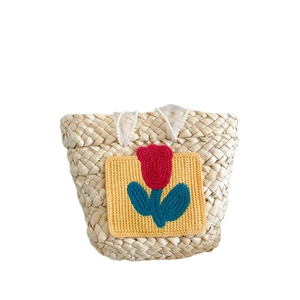 Handmade straw tote bag for girls with knit tulip patch and pearl handle accents