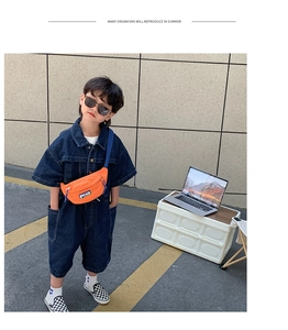 Détail d'une combinaison courte en jean pour enfant avec une sacoche banane orange