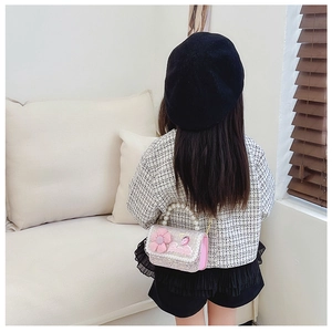 Kid pink glitter mini bag with 3D flower and pearl handle shown on child model back