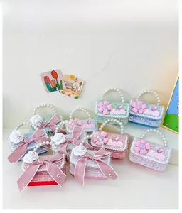 Detail of tweed mini purses with pearl handles and decorative floral bows for girls