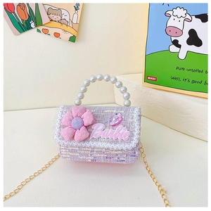 Detail of pink sequin tweed handbag with pearl handle and 3D floral accents