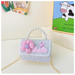 Detail of girls' blue sequin bag with pink flower, Barbie logo and pearl handle