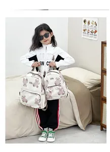 Detail of cute cartoon bear print kids backpacks in small and large sizes for school