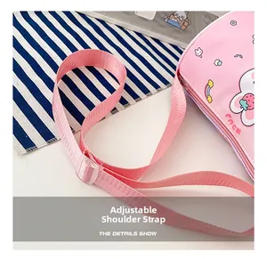 Detail show of adjustable pink shoulder strap on cute cartoon cylinder bag for girls