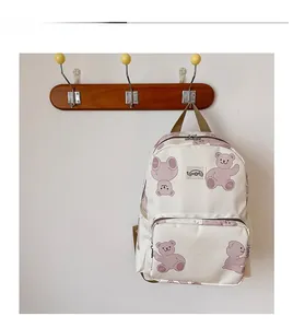 Detail display of cute cartoon bear print and front pocket on kids canvas backpack