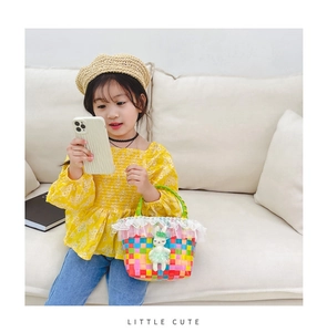 Détail du sac de plage tissé avec bordure en dentelle blanche et peluche lapin pour filles