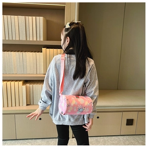 Pink cartoon rabbit cylinder crossbody bag for kids with adjustable strap shown on model