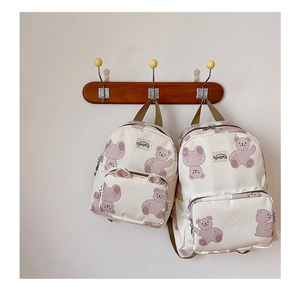 Detail view of cute bear pattern canvas backpacks in two sizes for kids and parents
