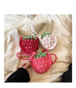 Detailaufnahme der Strickstruktur von Erdbeer-Häkeltaschen in Rot, Rosa und Creme