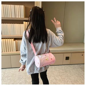 Pink cartoon rabbit cylinder crossbody bag shown on child model in cozy home setting
