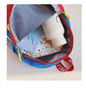 Interior view of kids colorful backpack showing capacity for water bottle and notebooks