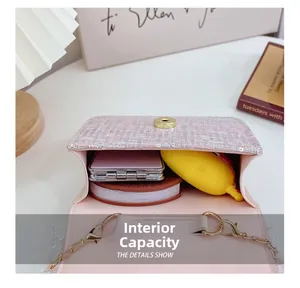 Internal capacity of pink tweed girl's crossbody bag showing storage space for accessories