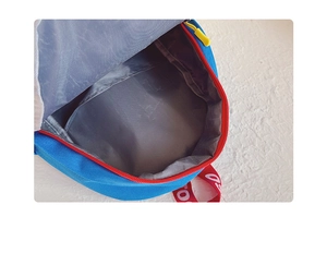 Detail of kindergarten backpack interior with red zipper and grey waterproof lining