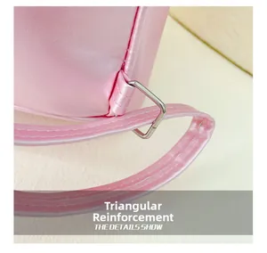 Détail d'un sac à dos rose en PU montrant la couture triangulaire et l'anneau en métal