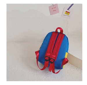 Detail of adjustable red straps and color-block canvas on kids mini backpack