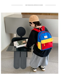 Detail of colorful patchwork canvas backpack for toddlers with blue and red straps