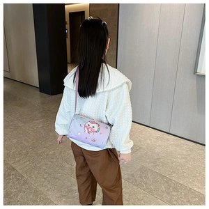 Detail of cute unicorn print on purple and blue gradient round crossbody bag for girls