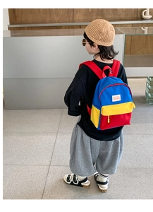 Detail view of colorful contrast kids backpack showing canvas texture and brand patch